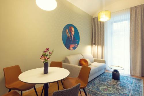 a living room with a couch and a table at LeonArt Living 12 in Graz