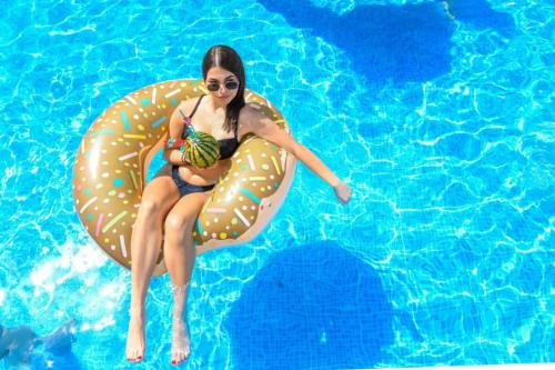 a woman is sitting on an inflatableynchronousynchronousynchronousynchronousynchronousynchronousynchronous at Vila sa bazenom Vrnjačka Idila in Vrnjačka Banja