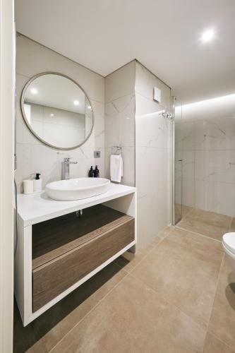 a bathroom with a sink and a mirror at Taksim Lagirio Residence in Istanbul
