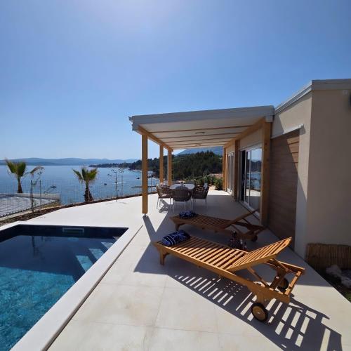 a villa with a swimming pool and a house at Lavanda Mobile Homes & Villas in Orebić