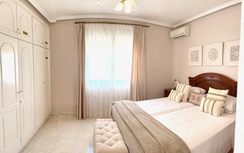 a bedroom with a large bed and a window at Casa Sara - Private Villa with Private Pool in Ciudad Quesada