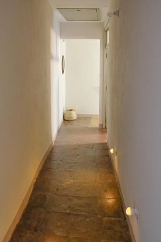 a hallway with a stone floor and a white wall at Panoramic Monferrato Villa With Garden & Amazing Views in Murisengo