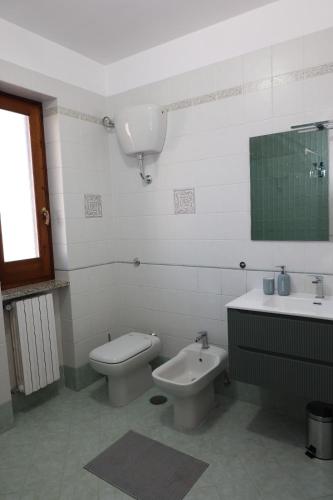 a white bathroom with a toilet and a sink at B&B Da Fifi in Castel San Giorgio