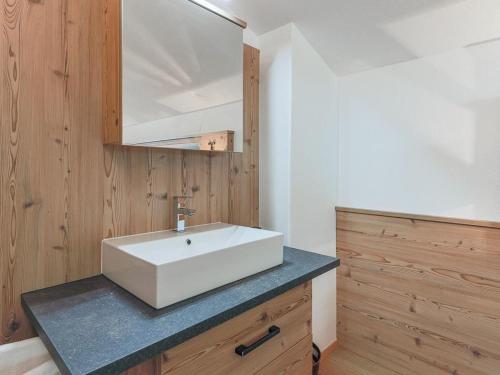 a bathroom with a white sink and a mirror at Appartement Riedmann in Brixen im Thale