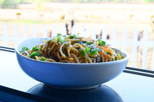 a bowl of noodles and vegetables on a table at Socials by bablos in Molem