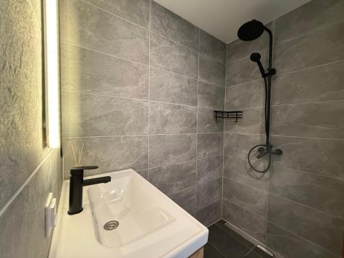 a bathroom with a sink and a shower at Männikumereääre with sea view and private beach in Kõrgessaare