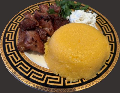 a plate of food with meat and rice on it at Diamond Hotel in Chişinău
