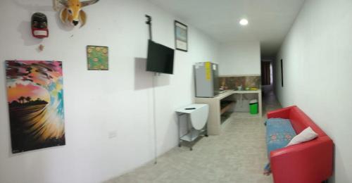 a living room with a red couch and a desk at Depto Zona UV Lagos Isleta 102 in Xalapa