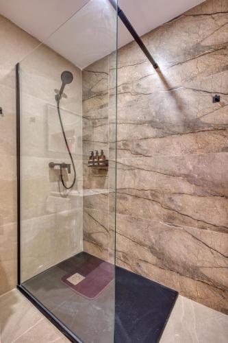 a shower with a glass door in a bathroom at Jade - Stylish Zabbar Hideaway in Żabbar
