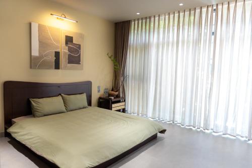 Ένα ή περισσότερα κρεβάτια σε δωμάτιο στο Thang Homestay - Vinhome Ocean Park 3, Van Giang, Hung Yen