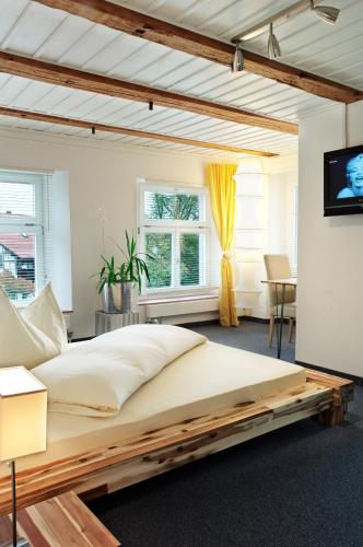 a bedroom with a large bed with a wooden frame at Gasthof Löwen in Bubikon