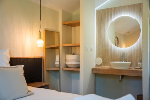 a bedroom with a sink and a mirror at Les Granges du Hautacam in Artalens-Souin