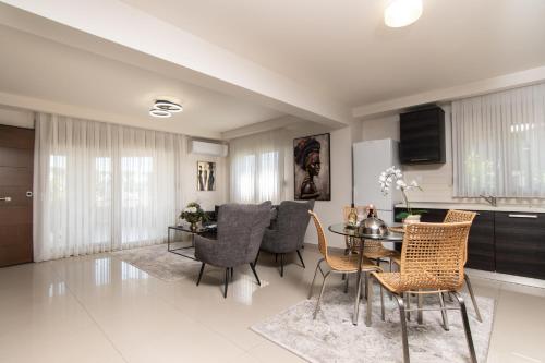 a kitchen and dining room with a table and chairs at Alexandra Boutique Residence VILLAS in Alexandroupoli