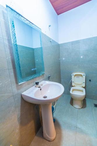 a bathroom with a sink and a toilet at Cinnamon Airport Residencies in Katunayaka