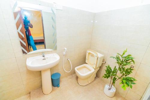 a bathroom with a sink and a toilet at Cinnamon Airport Residencies in Katunayaka