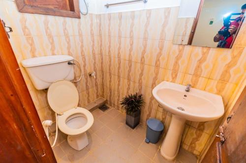 a bathroom with a toilet and a sink at Cinnamon Airport Residencies in Katunayaka