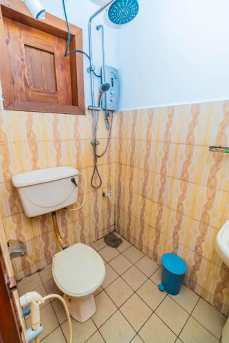 a bathroom with a toilet and a shower in it at Cinnamon Airport Residencies in Katunayaka