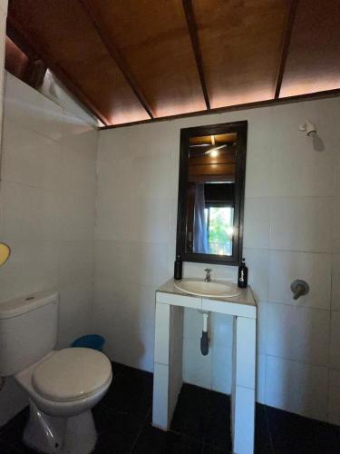 a bathroom with a toilet and a sink and a mirror at Talent Sunset Villa in Gili Islands