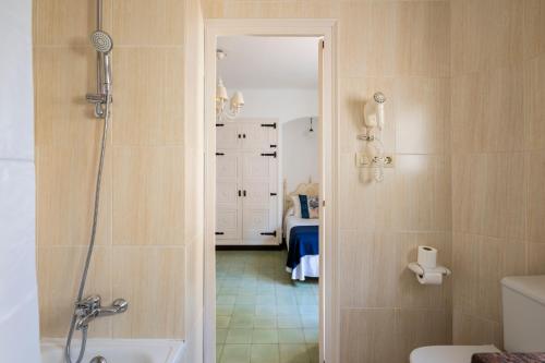 a bathroom with a shower and a toilet and a sink at La Goleta in Llança