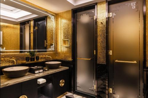 a bathroom with two sinks and two mirrors at THE KARL LAGERFELD in Macau