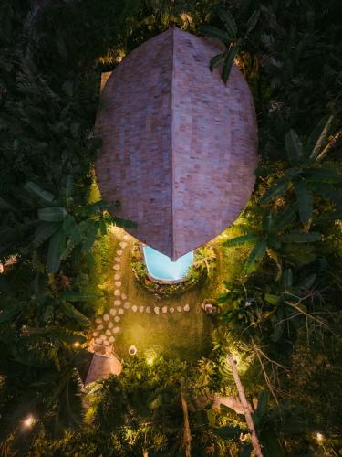 an overhead view of a garden with a brick wall at Trivana Sanctuary by Arcada Bali in Sidemen