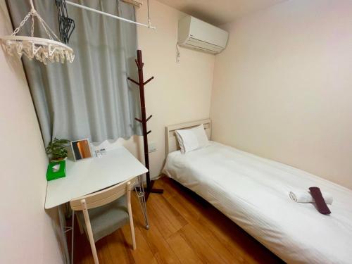Ένα ή περισσότερα κρεβάτια σε δωμάτιο στο Uhome Kamiitabashi Apartment