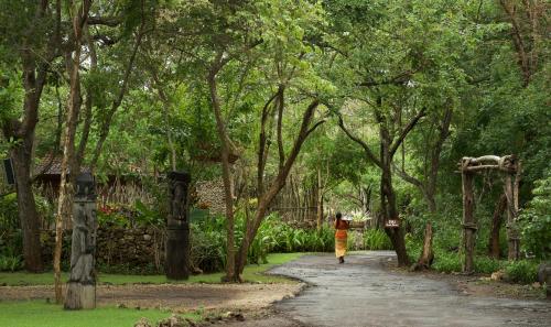 a person walking down a path in a park at Plataran Menjangan Resort and Spa - CHSE Certified in Banyuwedang