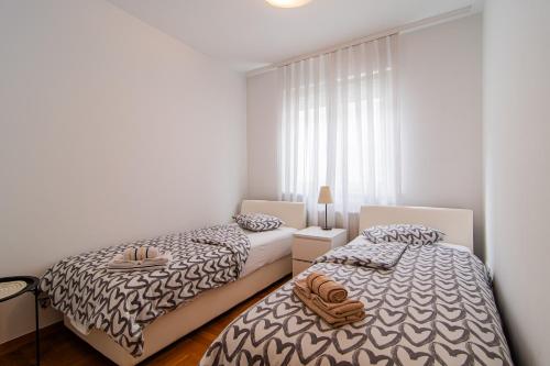 Voodi või voodid majutusasutuse Flexible SelfCheckIns 97 - Zagreb - Garden - Parking- Loggia - 2 Bedrooms toas