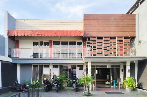 a building with motorcycles parked in front of it at TwoSpaces Living at Kutisari Residence, Surabaya in Surabaya
