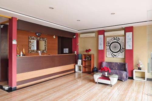 a living room with a counter and a couch at TwoSpaces Living at Kutisari Residence, Surabaya in Surabaya