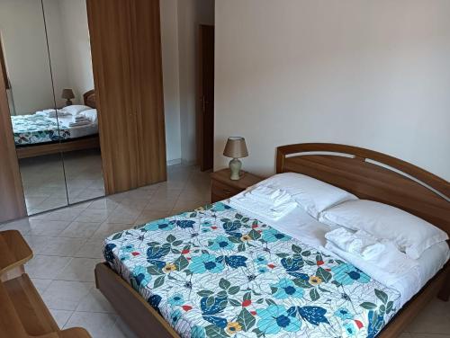 a bedroom with a bed with a quilt on it at Vincenzo Sea House in Belvedere Marittimo