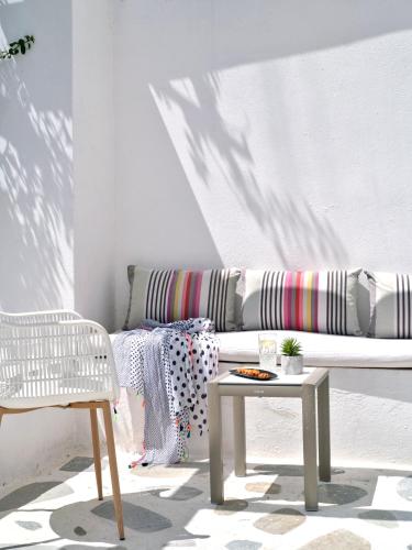 a living room with a couch and a table and a chair at Akrotiri Hotel in Parikia