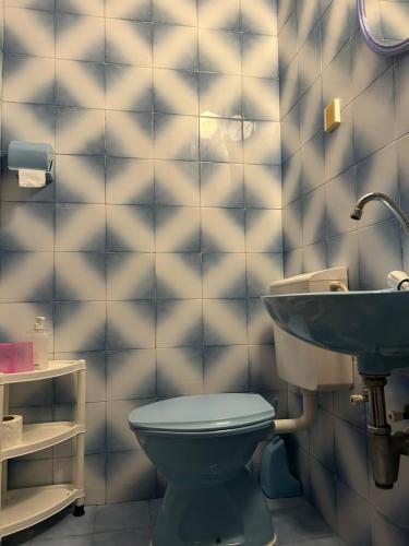 a bathroom with a toilet and a sink at Apartments and Room MV in Petrovac na Moru