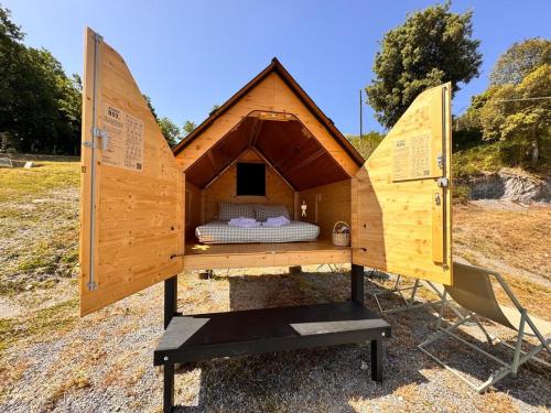a bed in a tiny house in a field at Podere Leucolea in Montagna