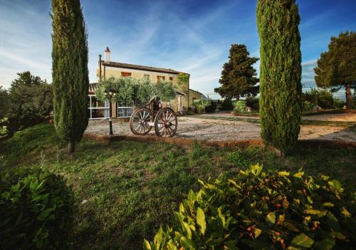 a bicycle parked in front of a house with trees at Briciola di Sole b&b e ristorante in Borgo