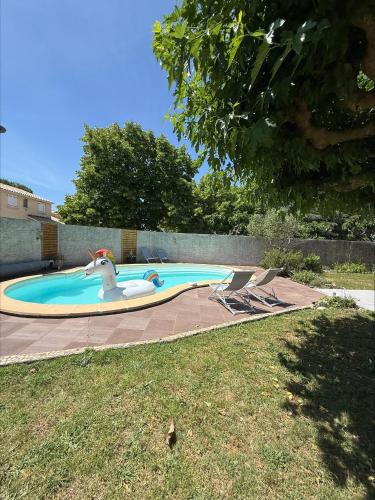 - une piscine avec un dauphin au milieu dans l'établissement Superbe Villa climatisée avec piscine, à Lavérune