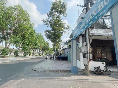 a street with motorcycles parked in front of a building at TRUNG LUONG HOMESTAY in My Tho