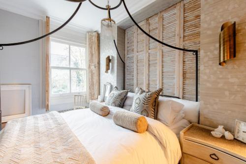 a bedroom with a large bed and a window at Stylishly Designed Private Home in Central Windsor in Windsor
