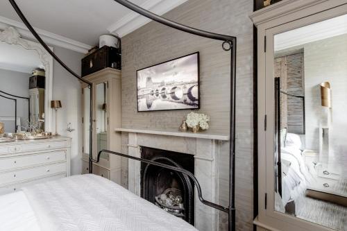 a bedroom with a fireplace in front of a bed at Stylishly Designed Private Home in Central Windsor in Windsor