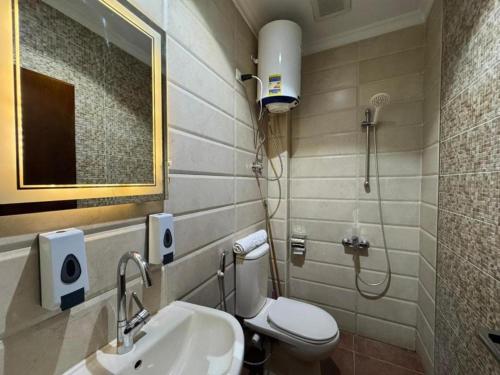 Un baño con inodoro, lavabo y ducha. en Lorenda hotel, en El Cairo