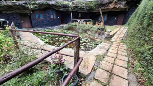 a set of stone steps leading to a house at Escape Natural Farm Stay - Cave 2 in Kanthalloor