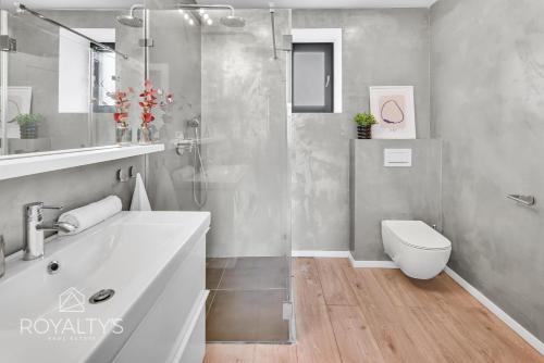 a bathroom with a shower and a sink and a toilet at Villa Senec in Senec