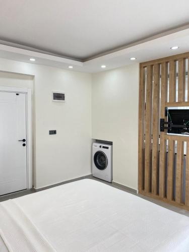 a laundry room with a washing machine and a door at Mutlu apart in the center of Fethiye in Fethiye