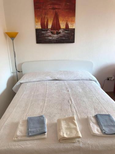 a bed with two towels sitting on top of it at La PAVONCELLA sul MARE in Tanaunella