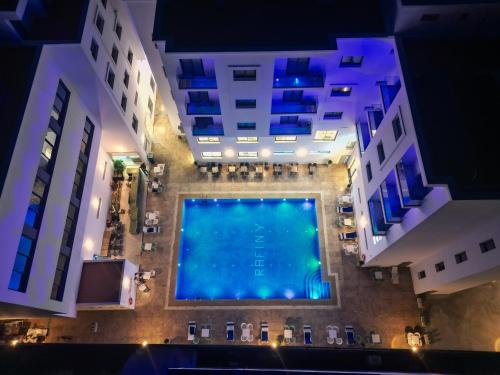 an overhead view of a large swimming pool in a building at Rafiny Hôtel in Ksar el Kebir