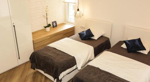 a room with two beds and a window at Moment Boutique Apartments in Belgrade