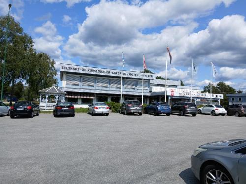 a parking lot with cars parked in front of a building at Høk Kro & Motell AS in Sarpsborg
