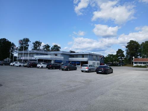 a parking lot with cars parked in front of a building at Høk Kro & Motell AS in Sarpsborg