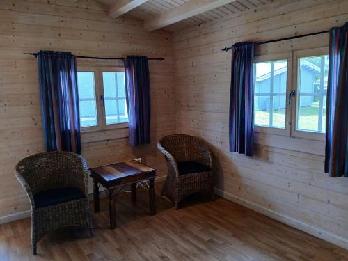 a room with a table and chairs and windows at Høk Kro & Motell AS in Sarpsborg
