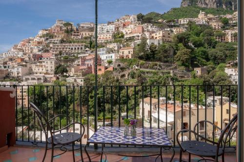 a table and chairs with a view of a city at Hotel Savoia in Positano